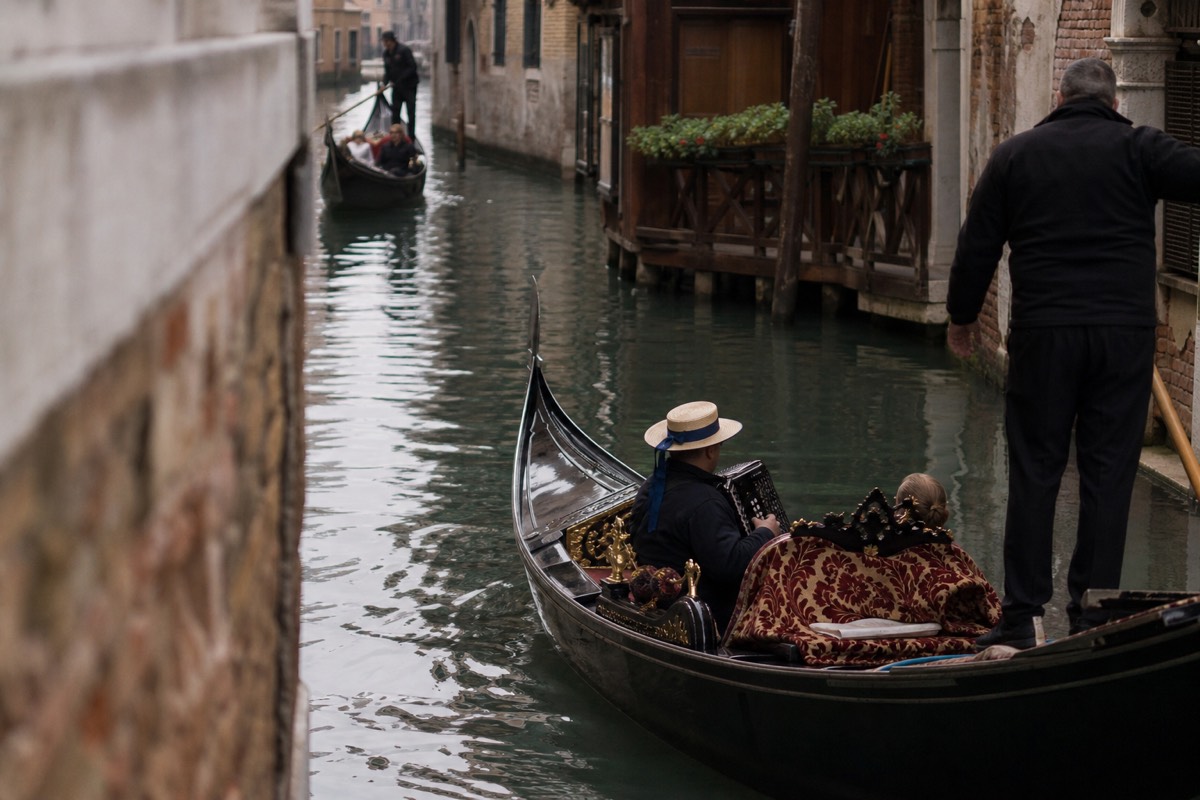 Gondola serenade in Venice with a musician playing aboard a gondola on the canal
